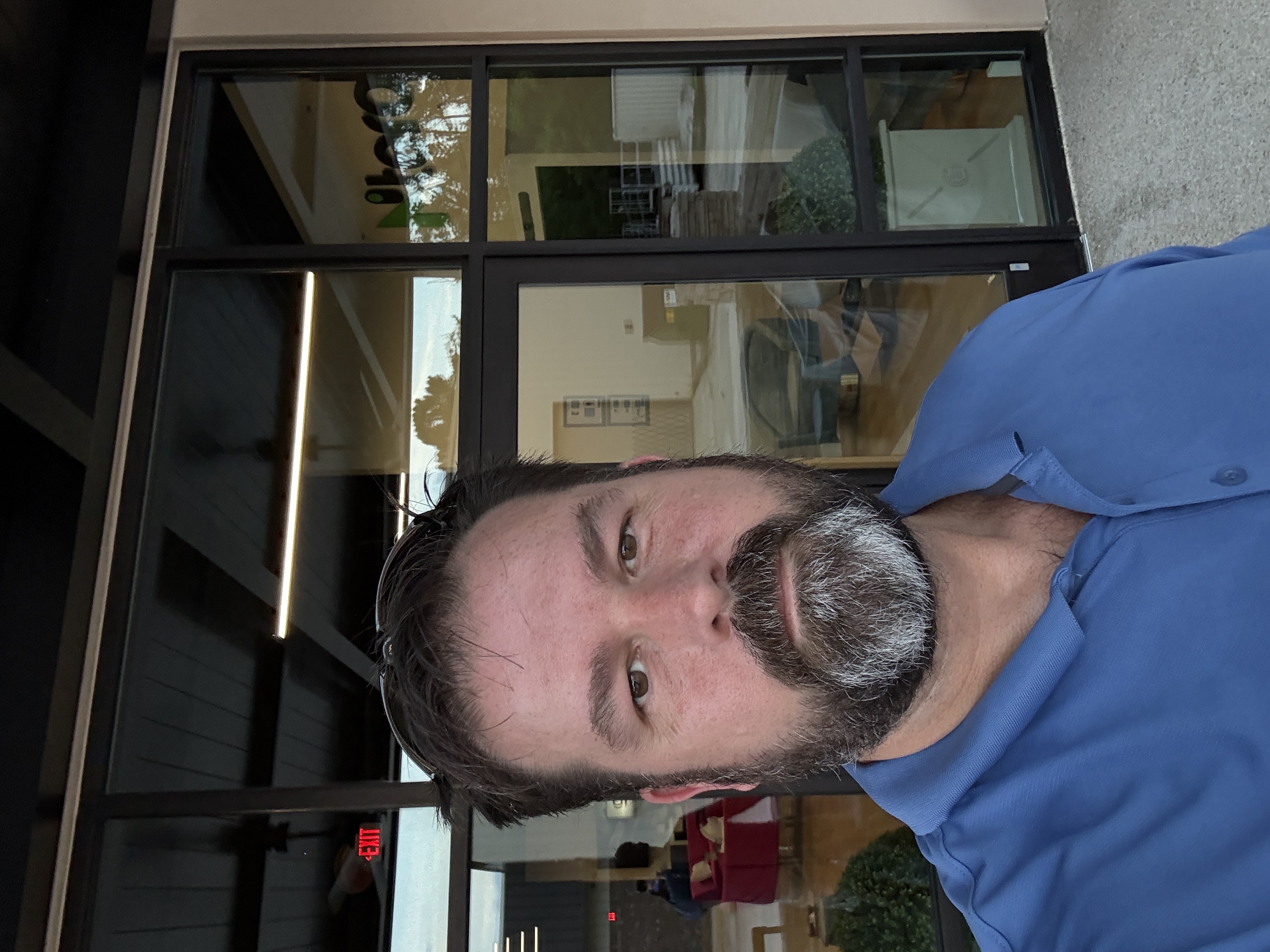 Professional window cleaner working on a modern building with crystal clear results